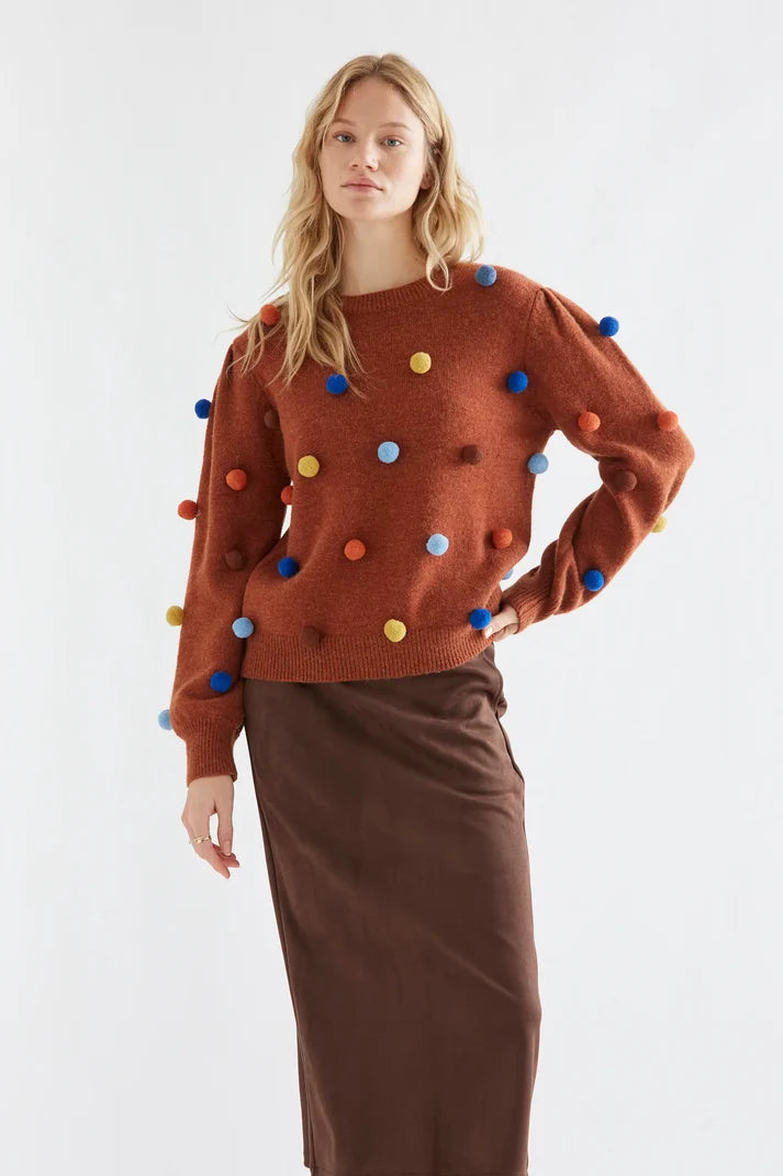 Brown knit sweater with multicolored pompoms