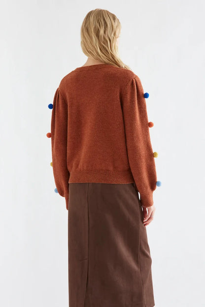 Brown knit sweater with multicolored pompoms